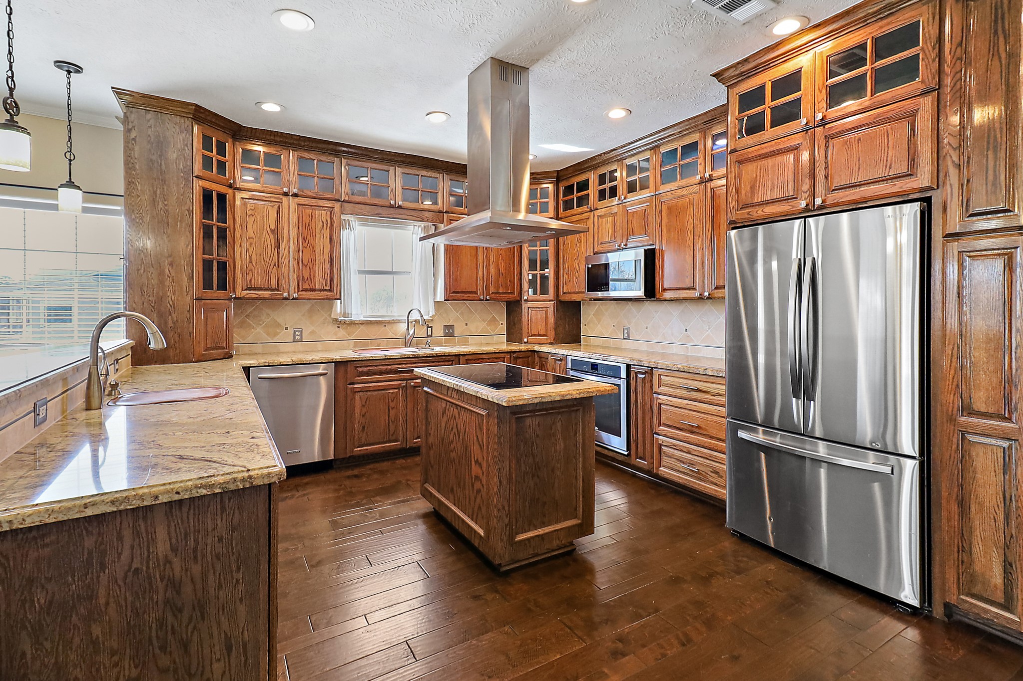 1306 Spring Branch Drive Baytown, TX 77523 - Photo 26 of 38 a kitchen with stainless steel appliances granite countertop a refrigerator a sink dishwasher a stove and a oven with wooden floor