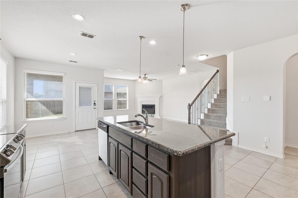 11301 Golden Ridge Lane Haslet, TX 76052 - Photo 11 of 35 a kitchen that has a sink a stove and a table