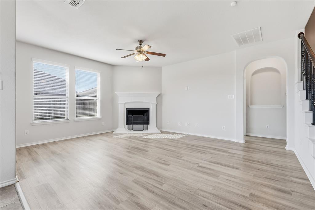 11301 Golden Ridge Lane Haslet, TX 76052 - Photo 14 of 35 a view of an empty room with a fireplace and a window