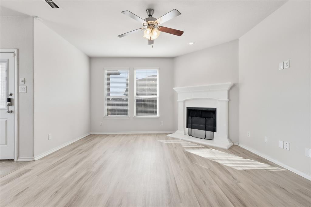 11301 Golden Ridge Lane Haslet, TX 76052 - Photo 15 of 35 an empty room with windows and a fireplace