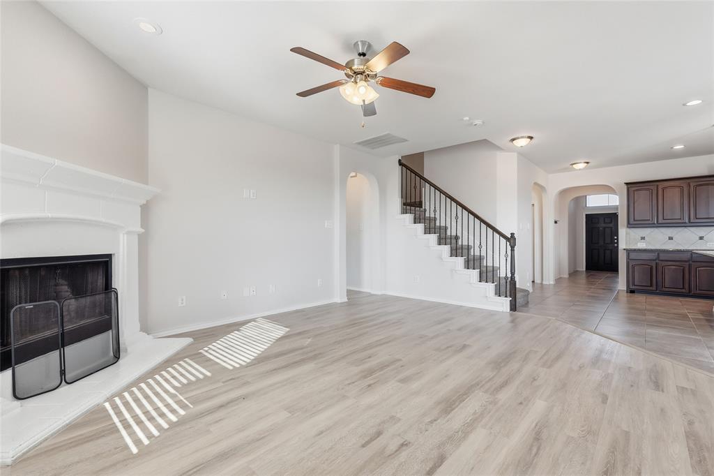 11301 Golden Ridge Lane Haslet, TX 76052 - Photo 34 of 35 a view of an empty room with wooden floor and a ceiling fan