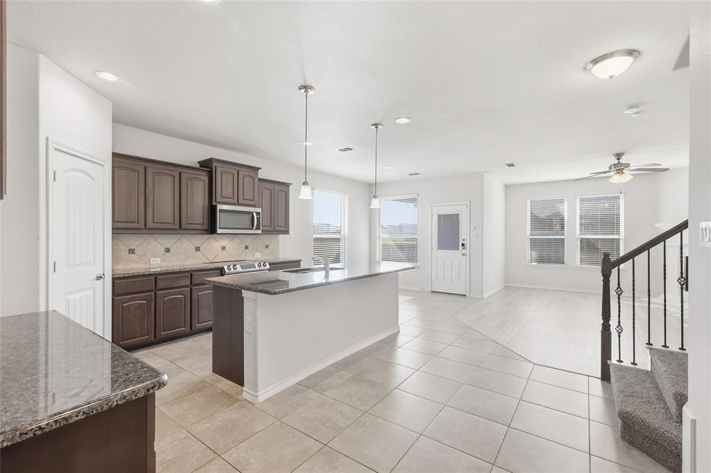 11301 Golden Ridge Lane Haslet, TX 76052 - Photo 9 of 35 a large kitchen with stainless steel appliances lots of counter top space and cabinets