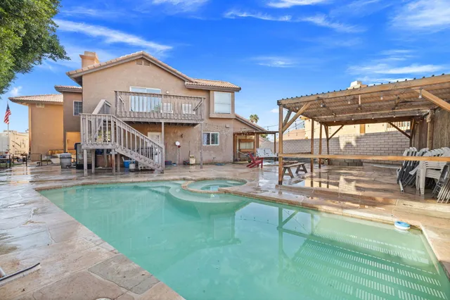 a living room with furniture a fireplace and a large window