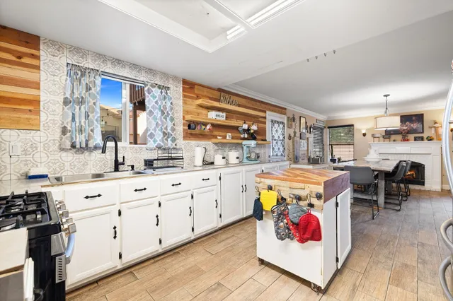 a kitchen with stainless steel appliances a stove sink and cabinets
