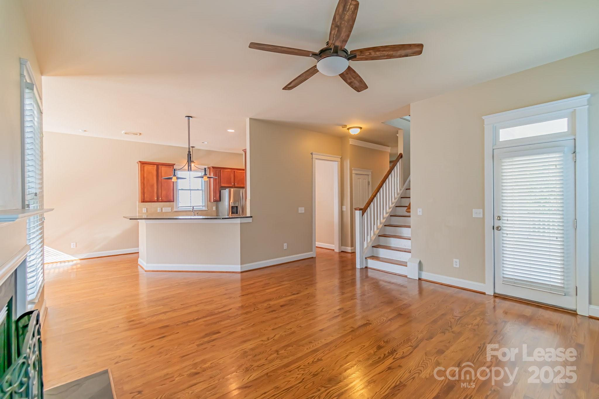 742 Revival Row Fort Mill, SC 29708 - Photo 12 of 32 a view of a room with wooden floor and ceiling fan