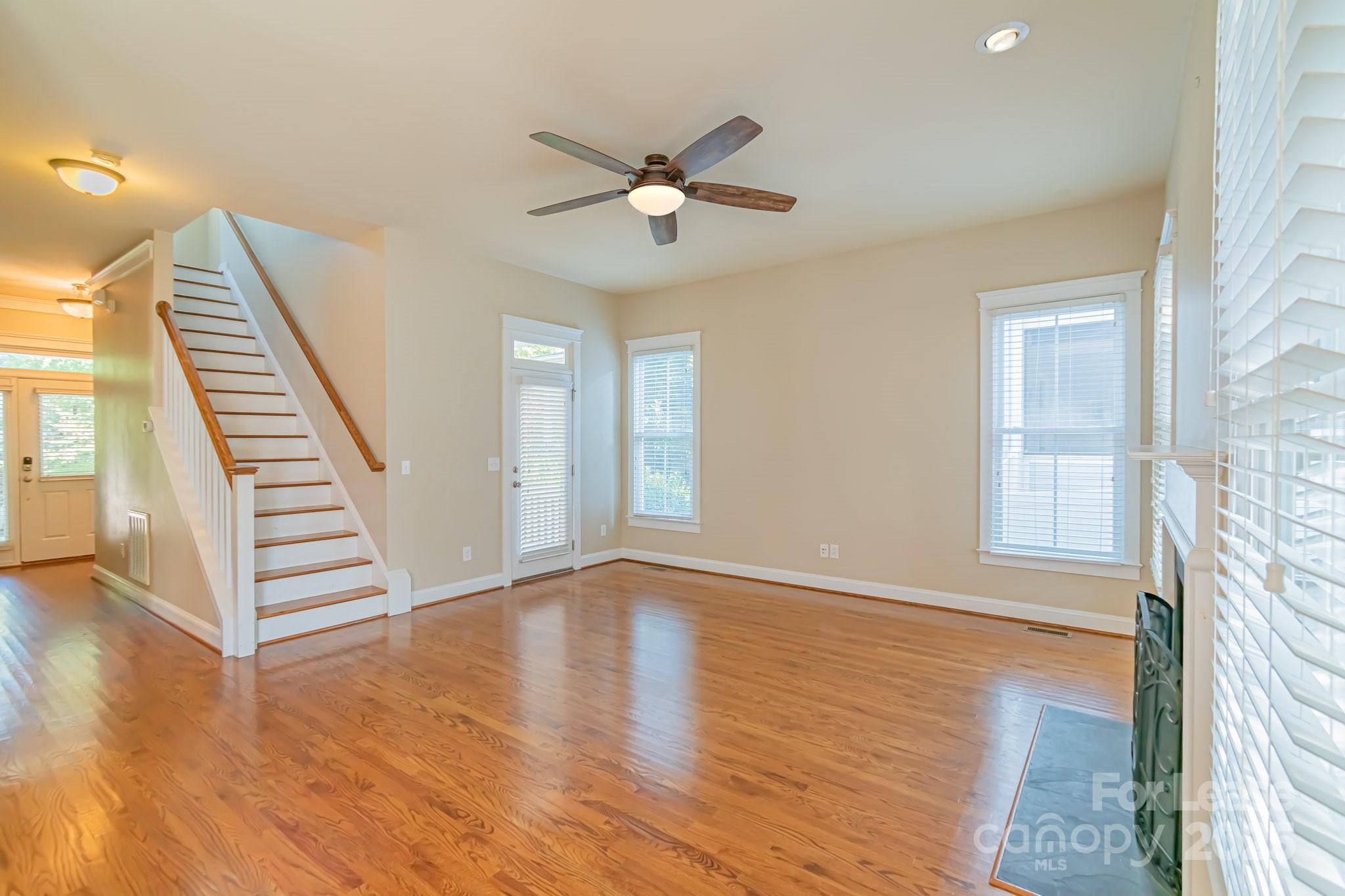 742 Revival Row Fort Mill, SC 29708 - Photo 13 of 32 a view of an empty room with wooden floor and a window