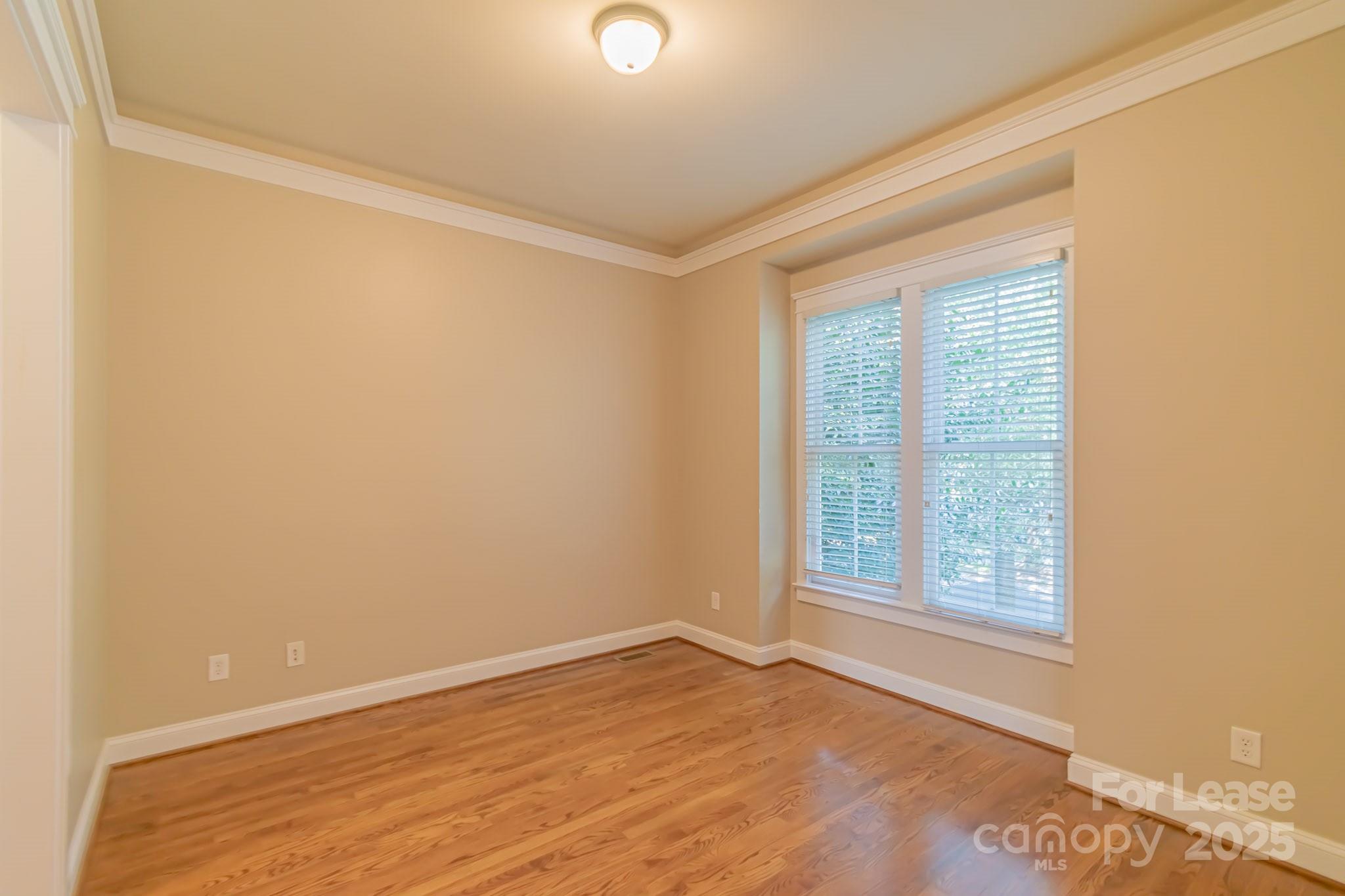742 Revival Row Fort Mill, SC 29708 - Photo 17 of 32 wooden floor in an empty room with a window