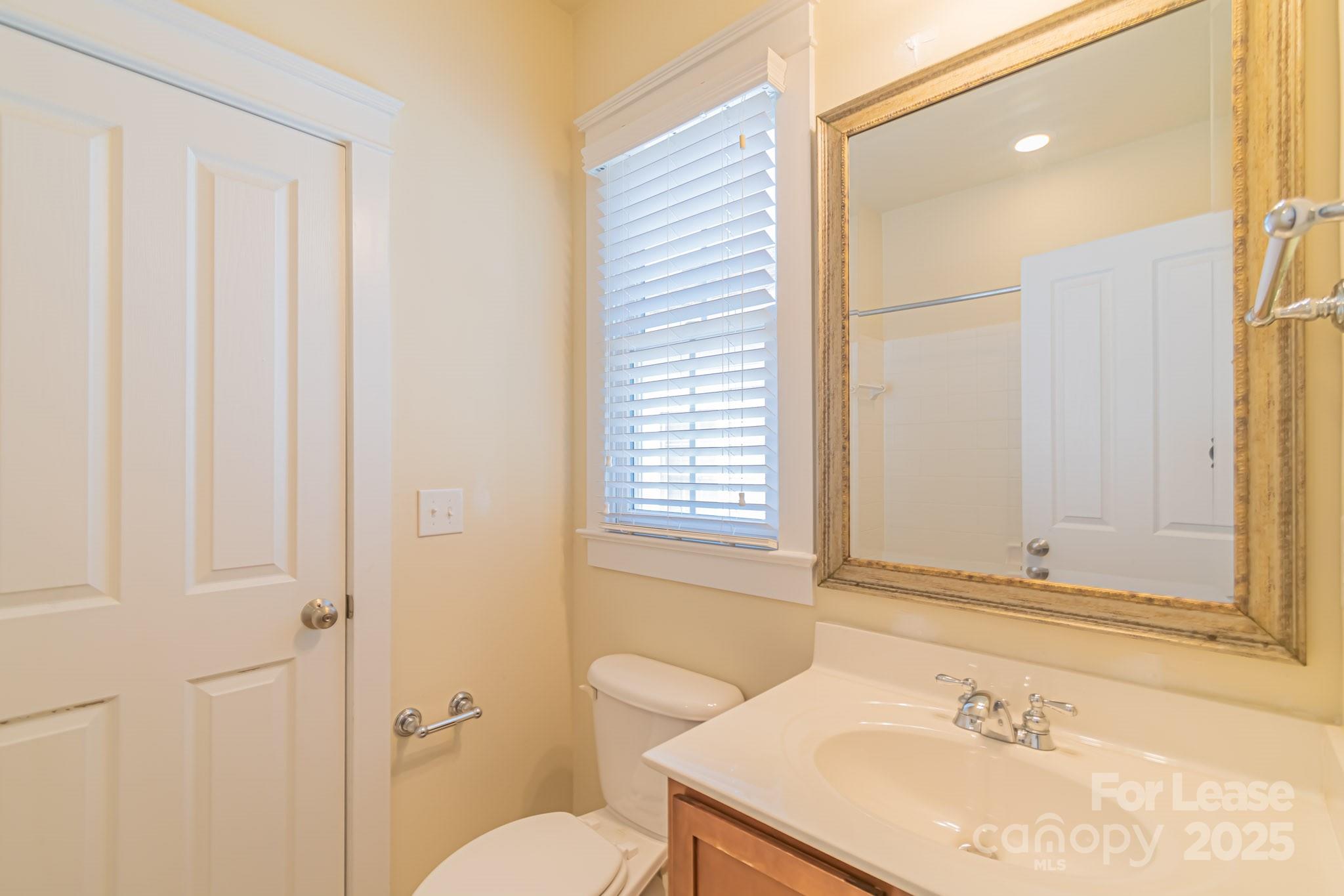 742 Revival Row Fort Mill, SC 29708 - Photo 25 of 32 a bathroom with a sink a toilet and shower