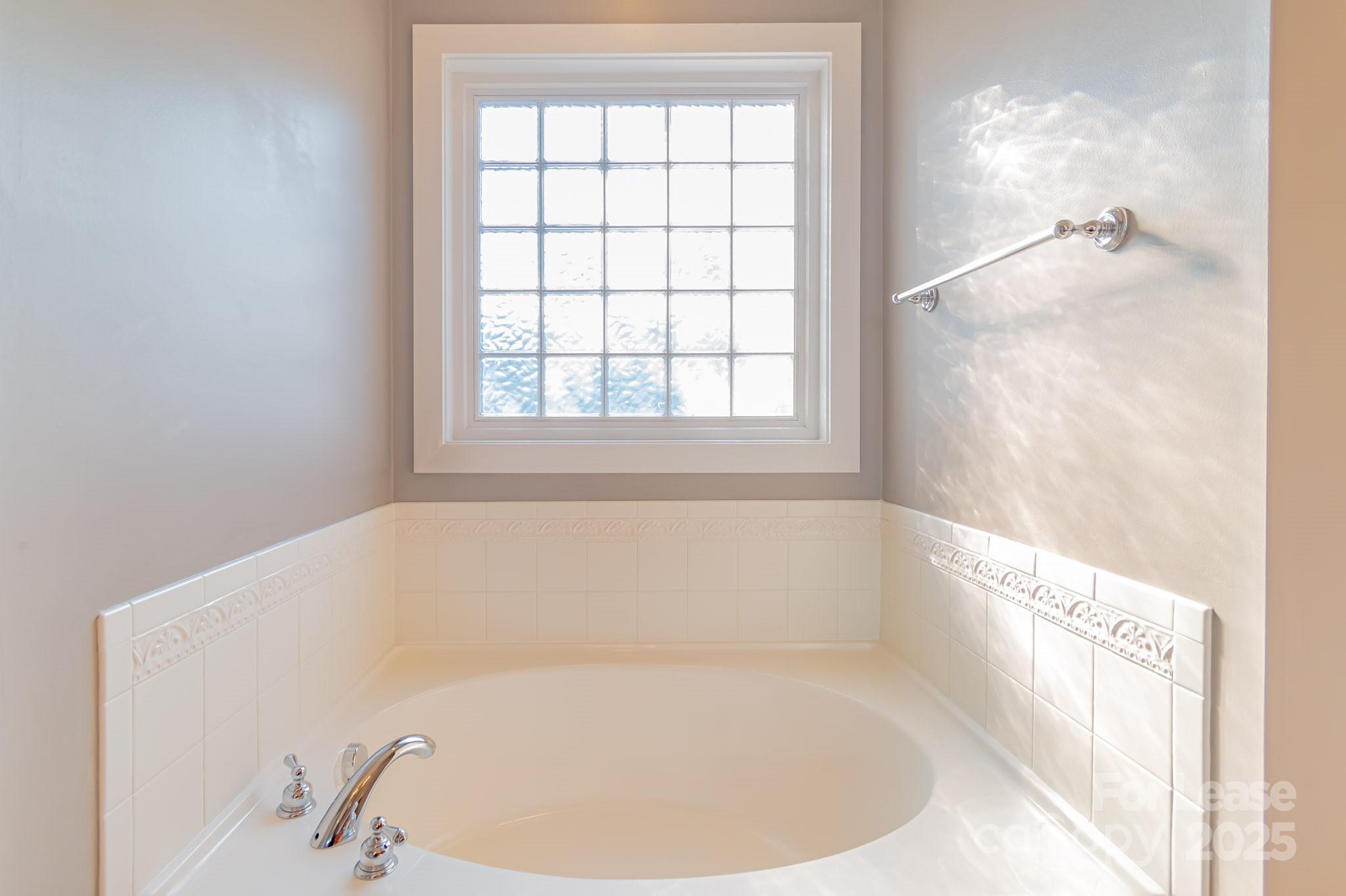 742 Revival Row Fort Mill, SC 29708 - Photo 28 of 32 a white bath tub sitting in a bathroom next to a window
