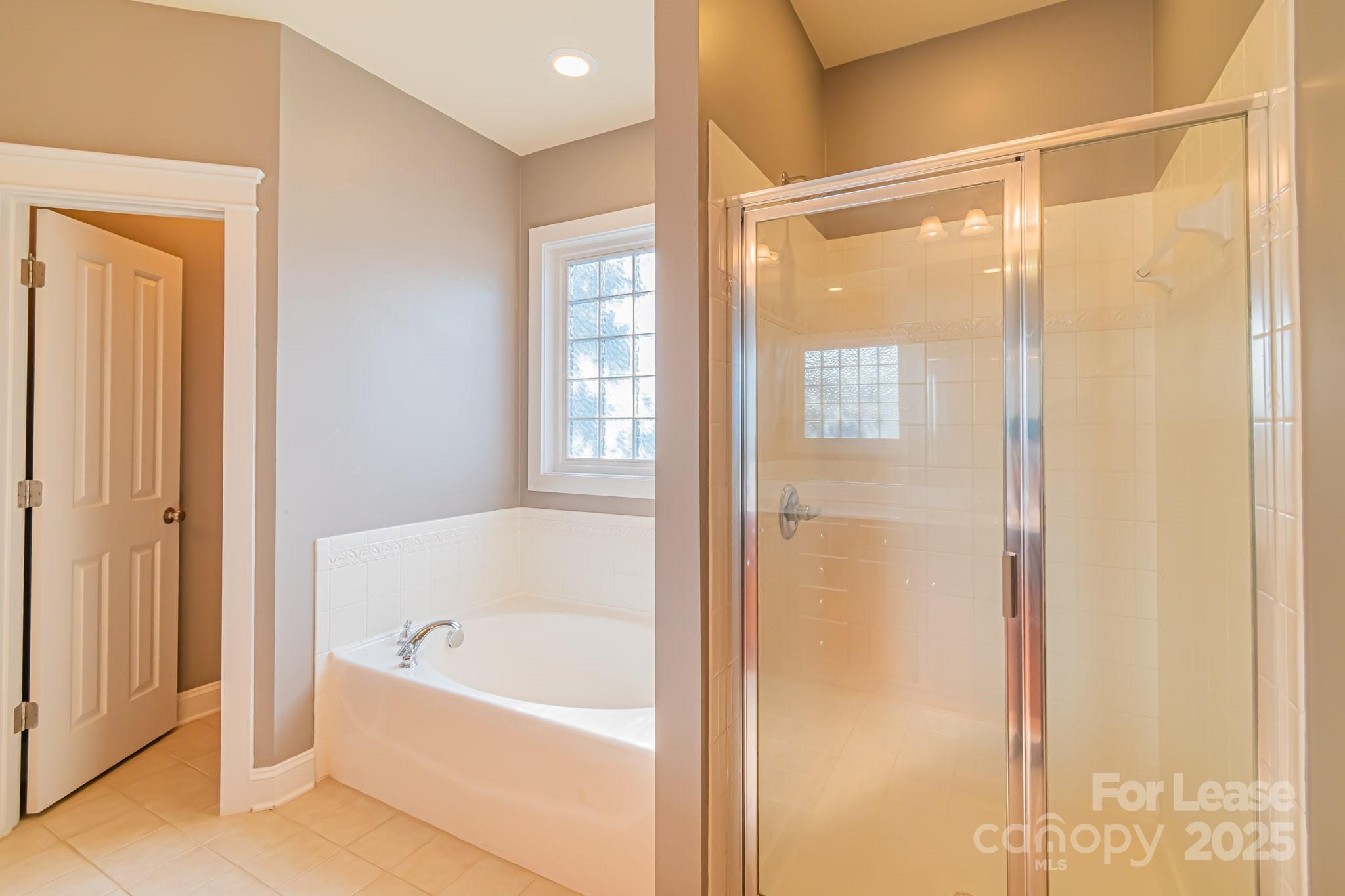 742 Revival Row Fort Mill, SC 29708 - Photo 29 of 32 a bathroom with a bathtub and a shower
