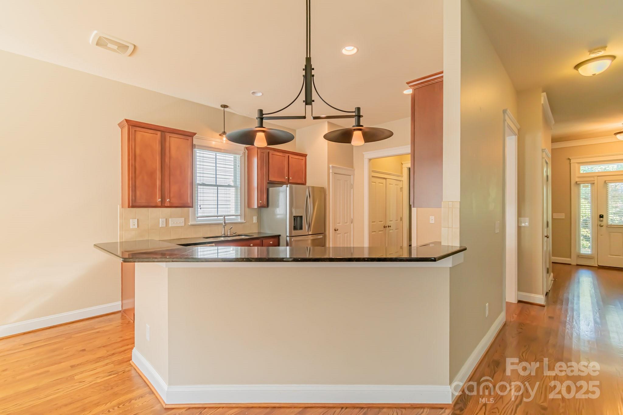 742 Revival Row Fort Mill, SC 29708 - Photo 7 of 32 a kitchen with stainless steel appliances granite countertop a sink and a refrigerator