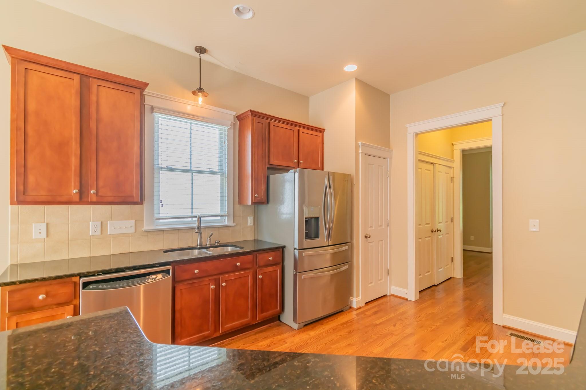 742 Revival Row Fort Mill, SC 29708 - Photo 8 of 32 a kitchen with stainless steel appliances granite countertop a refrigerator and a sink