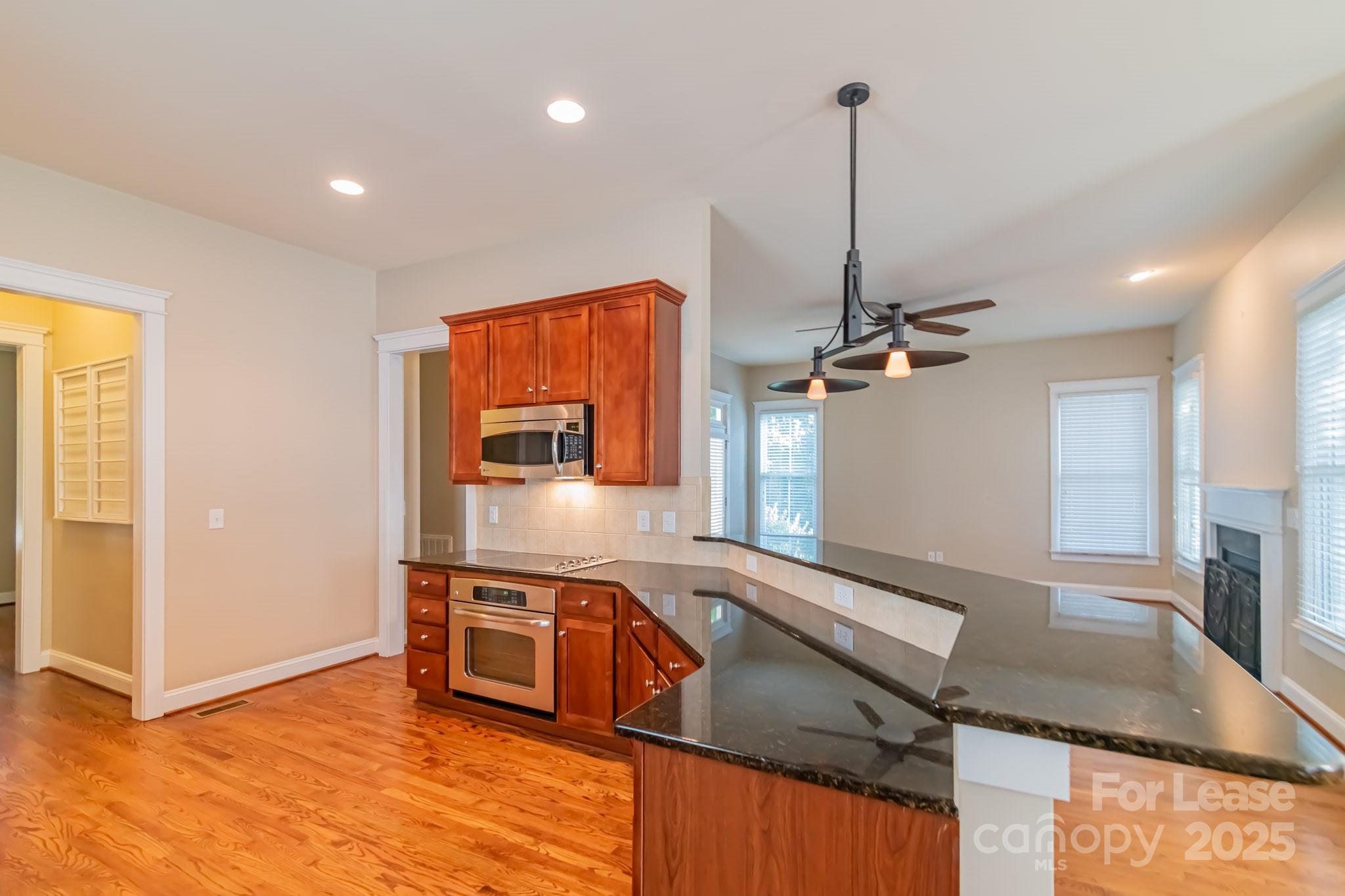 742 Revival Row Fort Mill, SC 29708 - Photo 9 of 32 a kitchen with stainless steel appliances granite countertop a sink a stove and a refrigerator