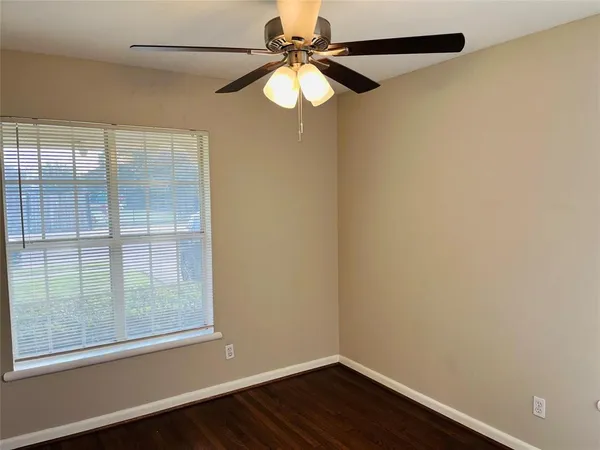 a view of a small space with wooden floor and a window