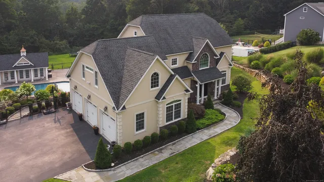 an aerial view of a house with a yard