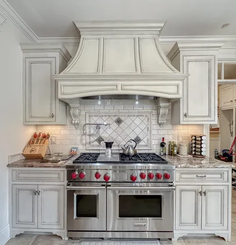 a kitchen with stainless steel appliances granite countertop a stove and a sink