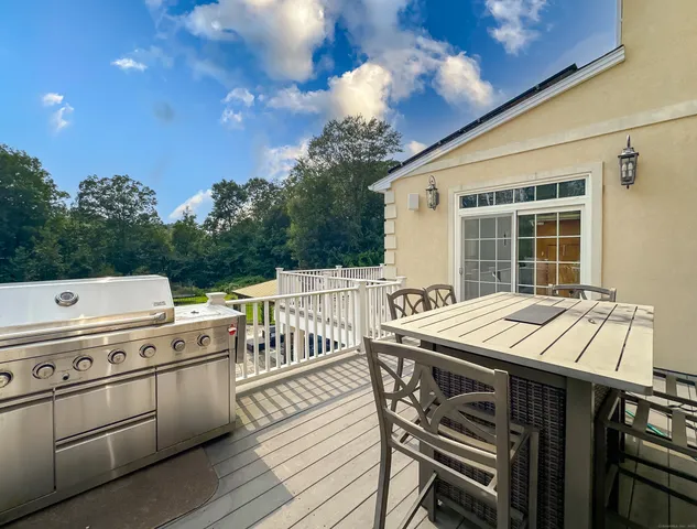 a view of a deck with table and chairs with wooden floor