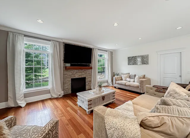 a living room with furniture fireplace and flat screen tv