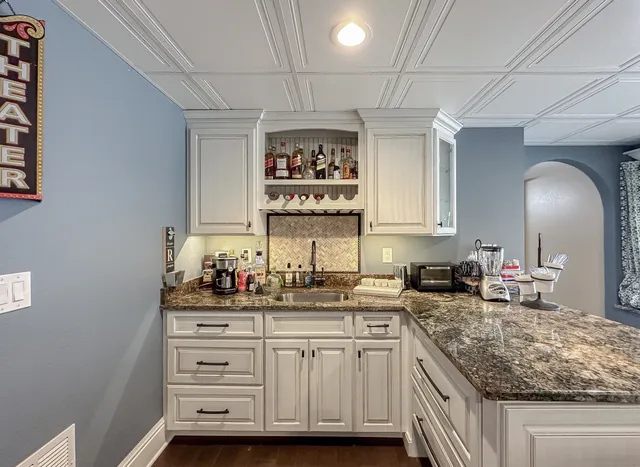 a pool table with chairs and couches