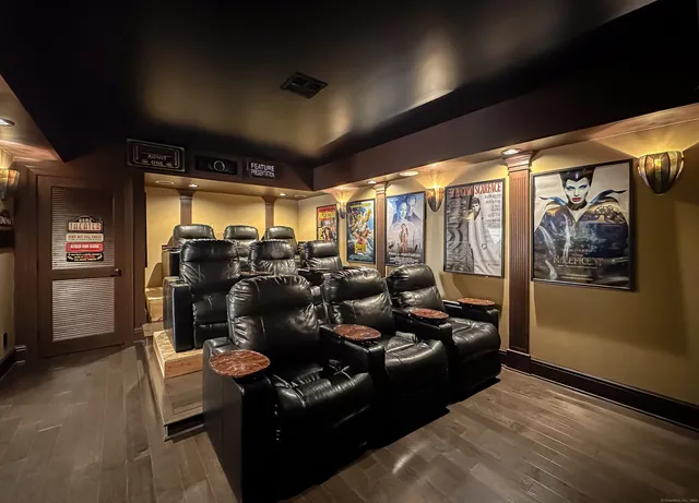 a living room with furniture a large window and a rug