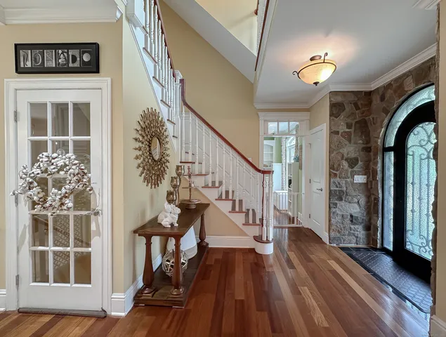 a view of entryway with wooden floor and stairs