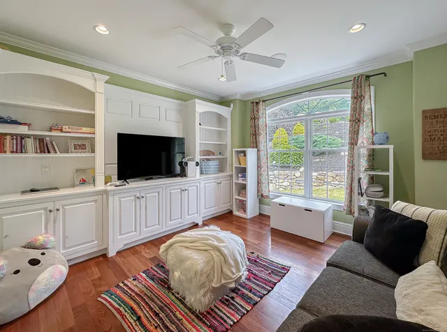 a living room with furniture and a flat screen tv