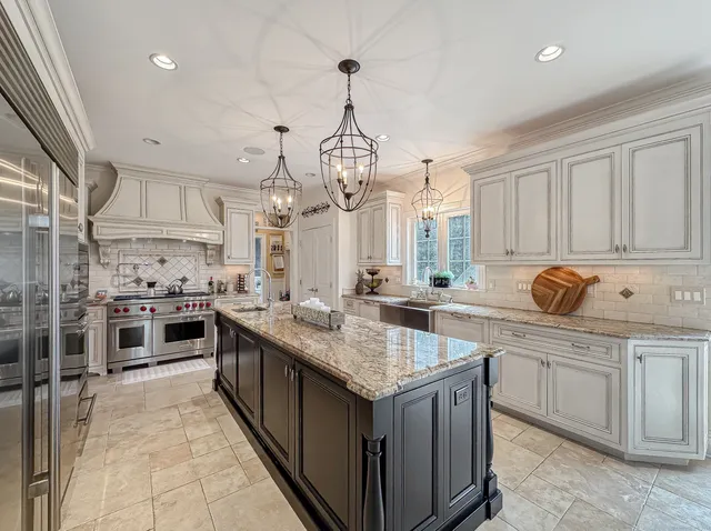 a kitchen with stainless steel appliances granite countertop a stove oven and a sink