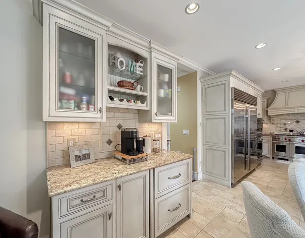 a kitchen with granite countertop a sink stainless steel appliances and cabinets