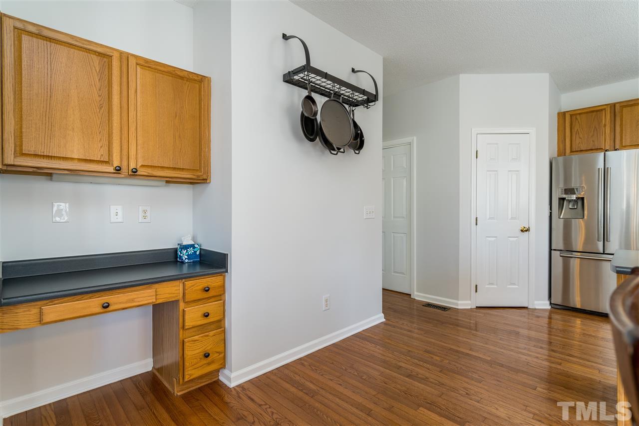 5221 Denmead Way Raleigh, NC 27613 - Photo 15 of 28 Clean kitchen with stainless steel appliances and open concept! Built in desk for paying bills or working from home!