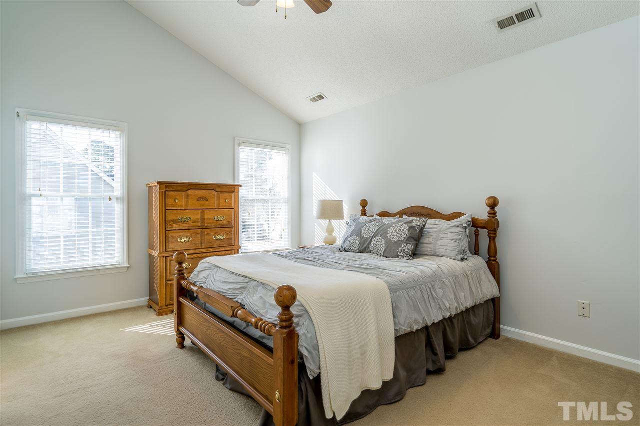 5221 Denmead Way Raleigh, NC 27613 - Photo 18 of 28 Light-filled owner's suite with vaulted ceilings and en suite bathroom and walk in closet!