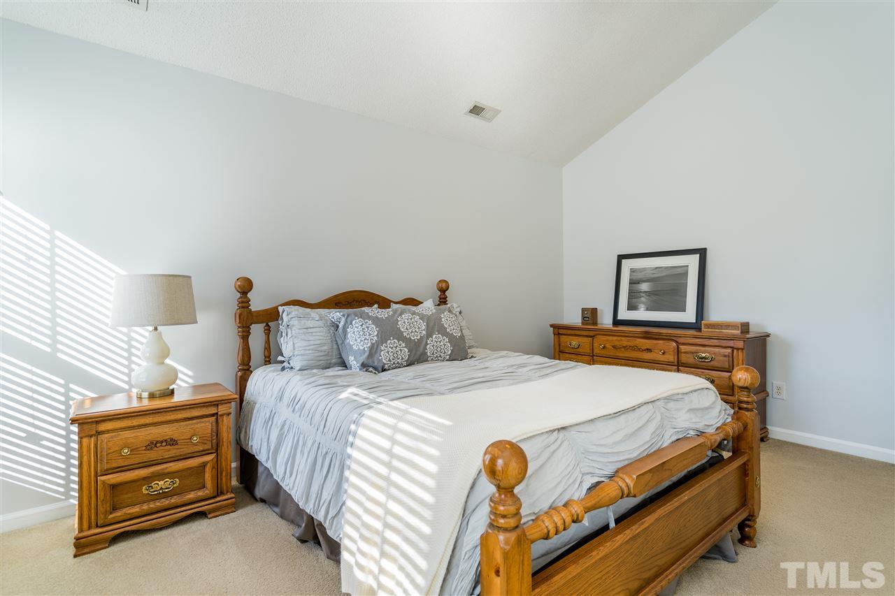 5221 Denmead Way Raleigh, NC 27613 - Photo 19 of 28 Light-filled owner's suite with vaulted ceilings and en suite bathroom and walk in closet!
