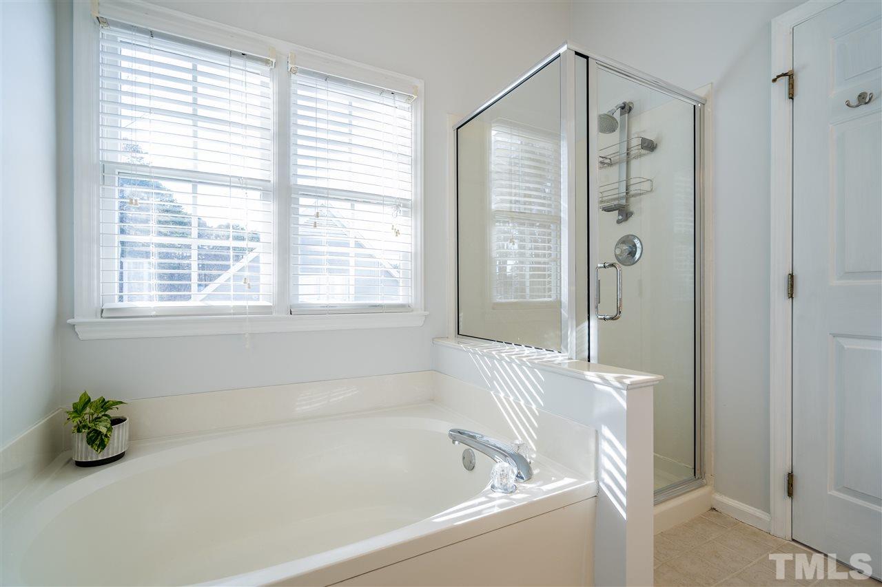 5221 Denmead Way Raleigh, NC 27613 - Photo 22 of 28 Owner's suite bathroom with glass enclosed shower, garden tub and dual vanities!