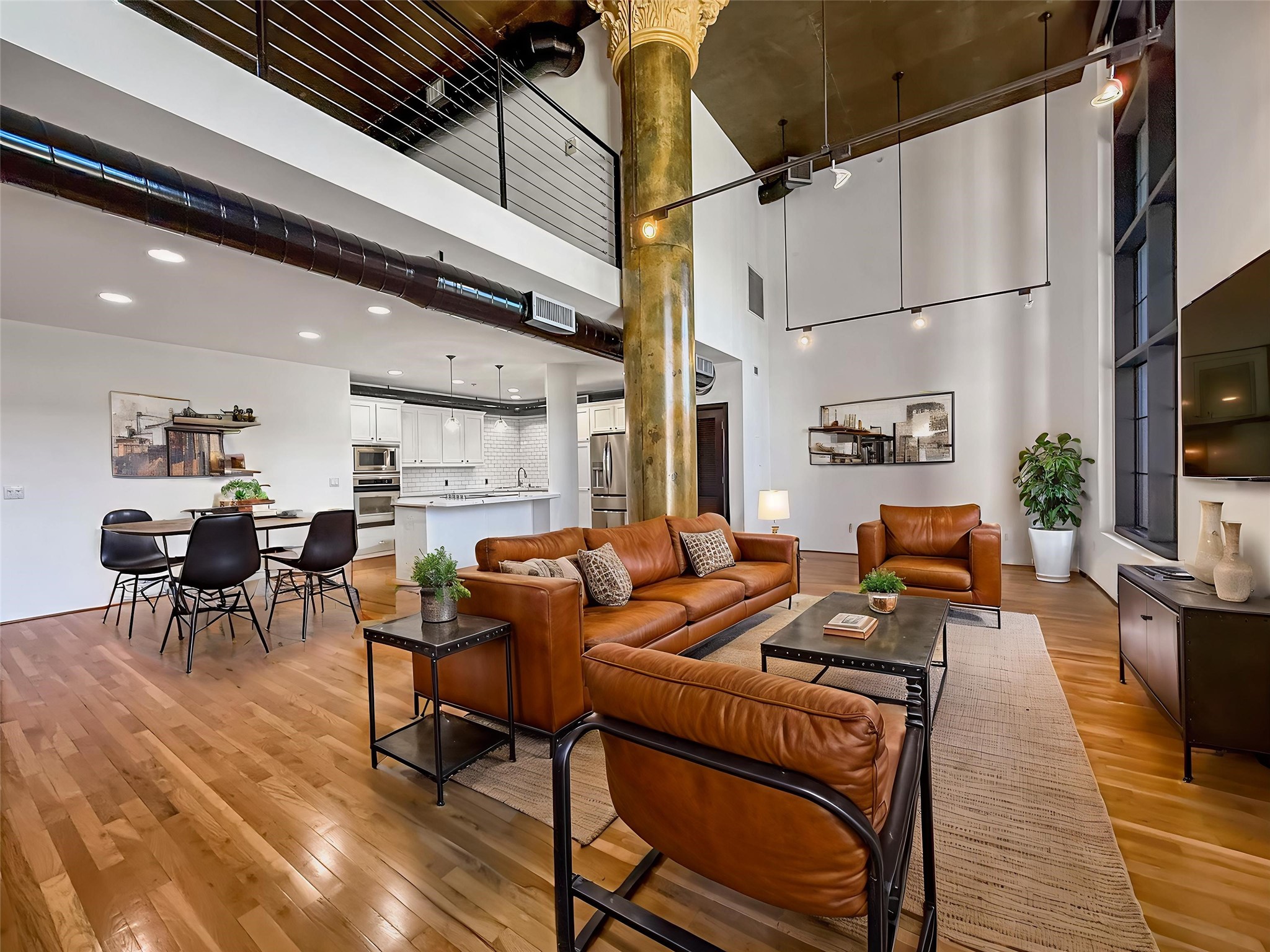 Experience modern sophistication in this virtually staged loft, featuring soaring ceilings, sleek industrial elements, and a seamless flow from the chic living area to the stylish kitchen, perfect for contemporary living.