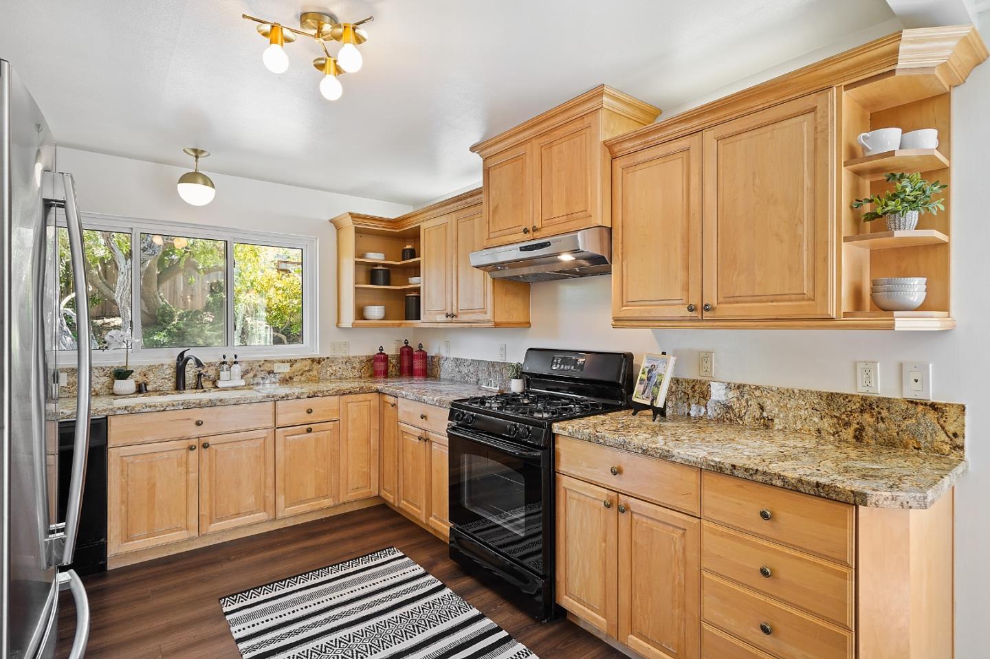 2805 Rivera Drive Burlingame, CA 94010 - Photo 11 of 28 a kitchen with granite countertop a sink stainless steel appliances and cabinets