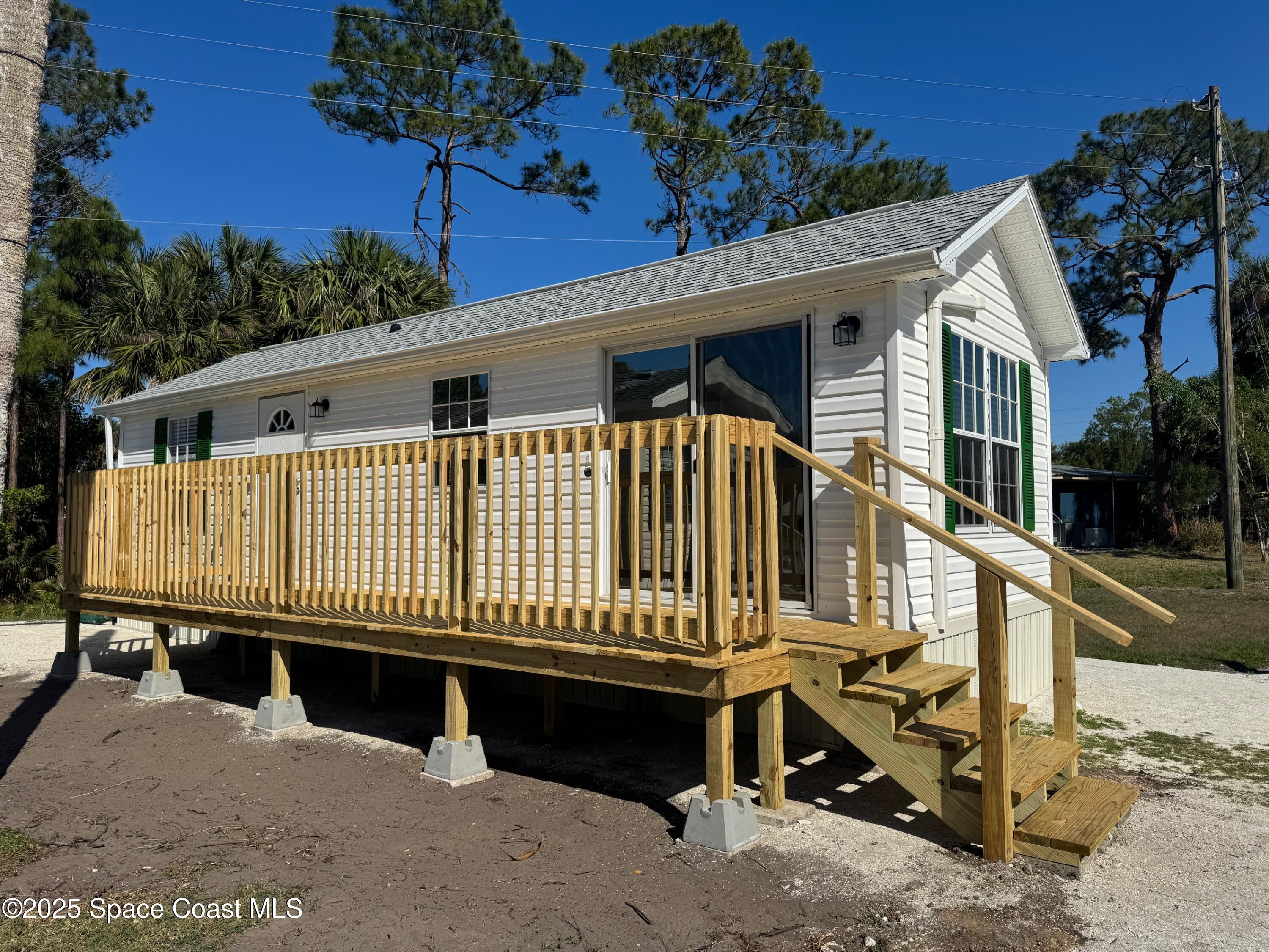 a view of a house with a wooden deck