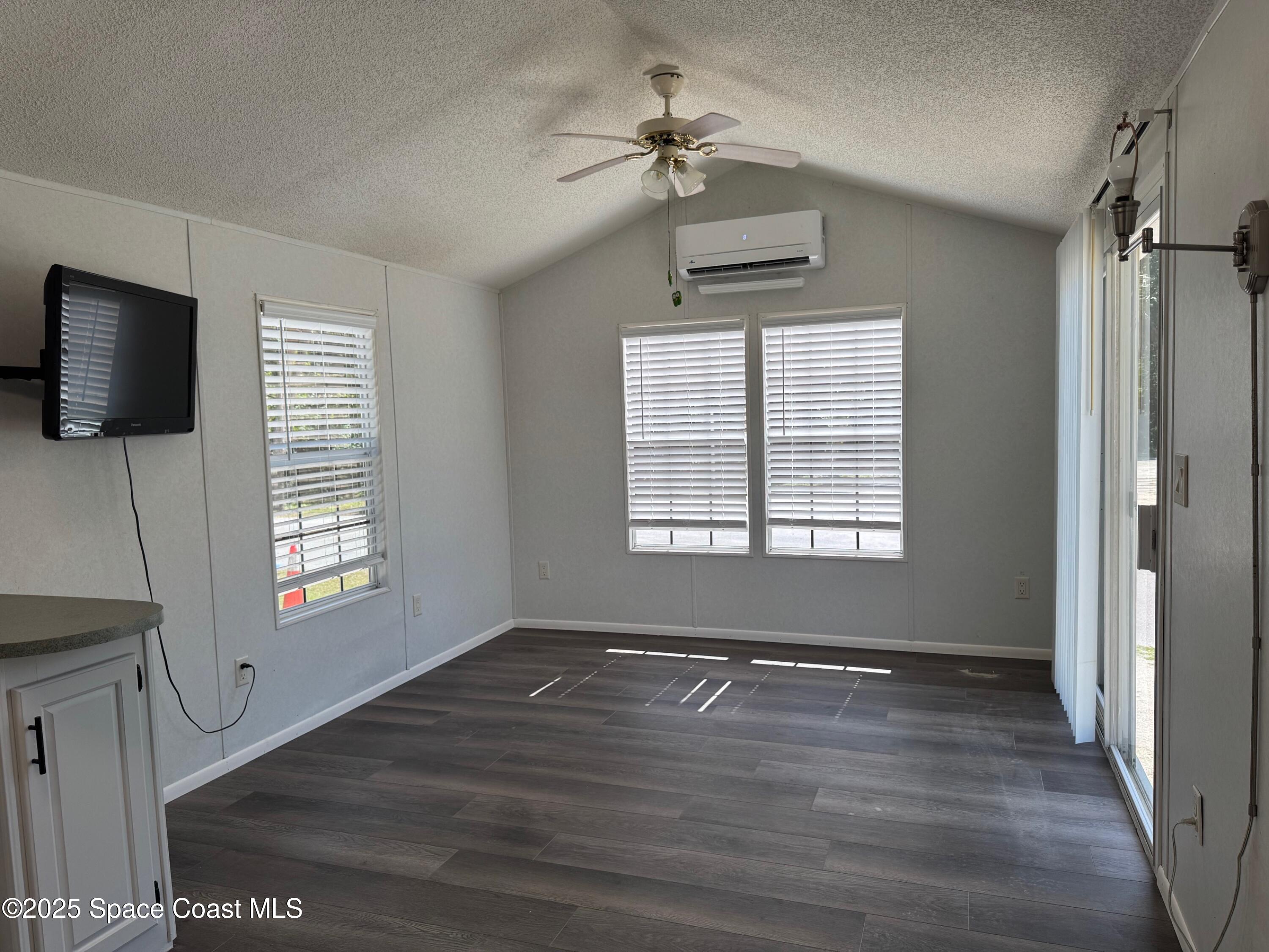 657 Snowbird Avenue, Unit 202 Cocoa, FL 32926 - Photo 2 of 6 a view of an empty room with a window and wooden floor