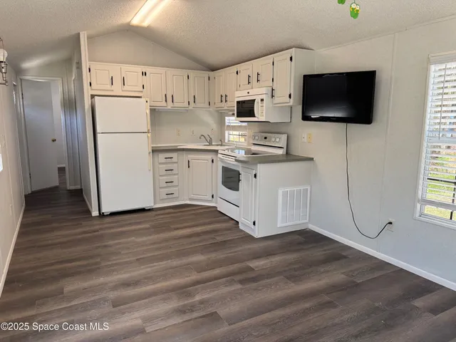 a kitchen with stainless steel appliances a refrigerator stove and microwave