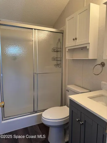 a bathroom with a toilet and a shower