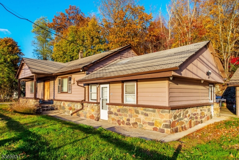 148 Highway 181 Lake Hopatcong, NJ 07849 - Photo 21 of 26 a front view of a house with a yard