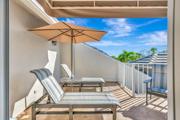 a view of balcony with wooden floor and outdoor seating