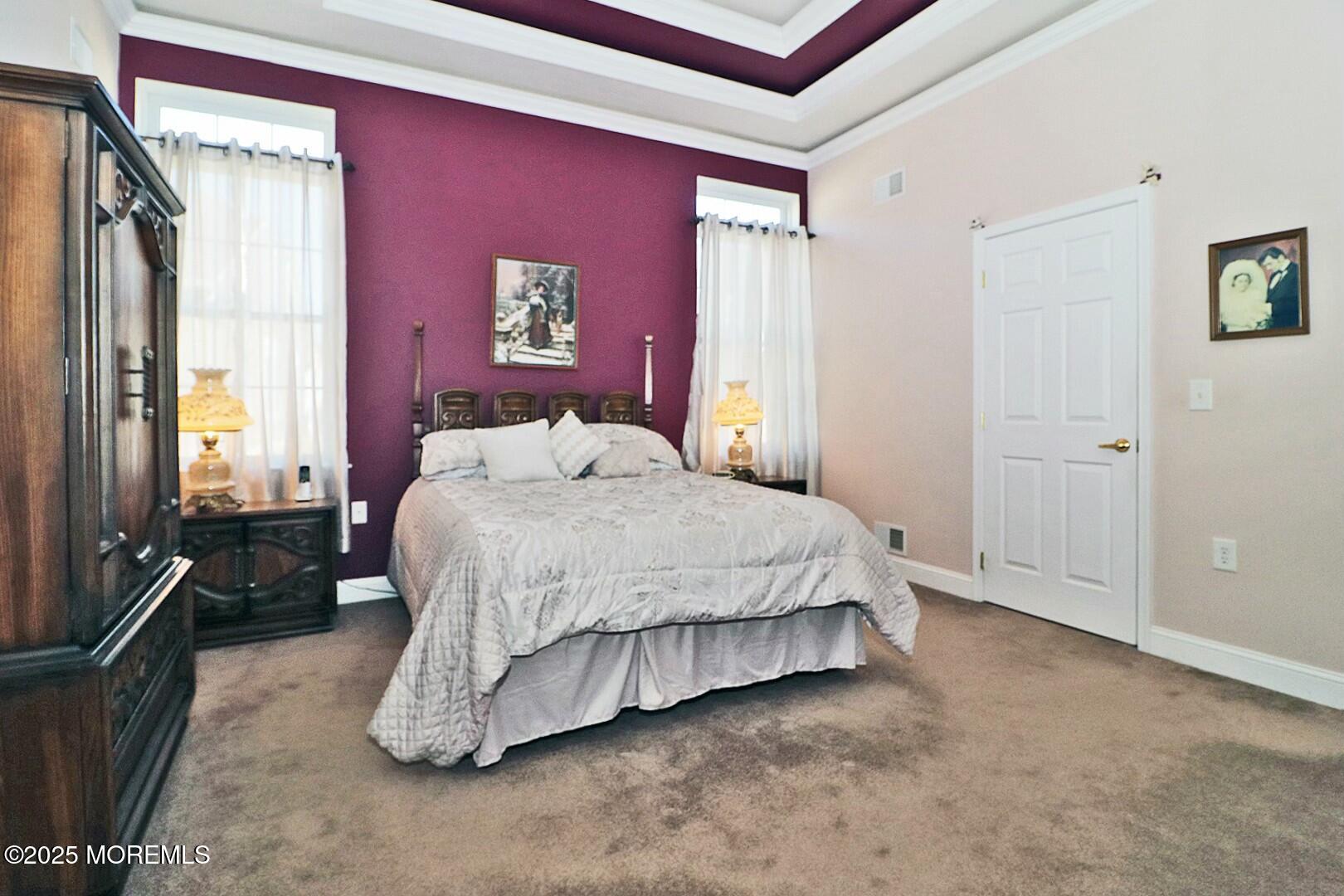 2 Manasquan Road Waretown, NJ 08758 - Photo 30 of 91 a spacious bedroom with a bed and dresser with mirror