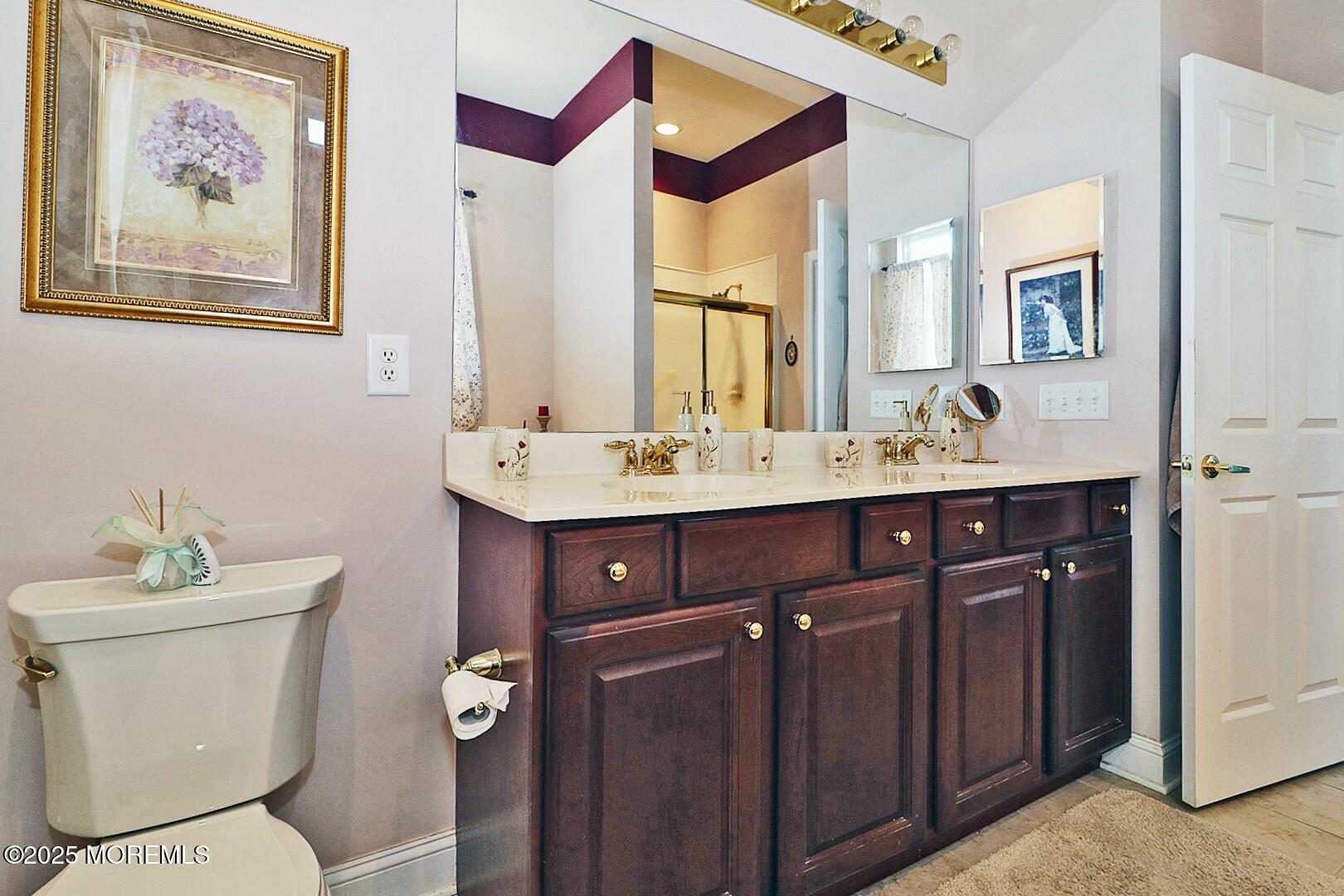 2 Manasquan Road Waretown, NJ 08758 - Photo 35 of 91 a bathroom with a toilet a sink and mirror