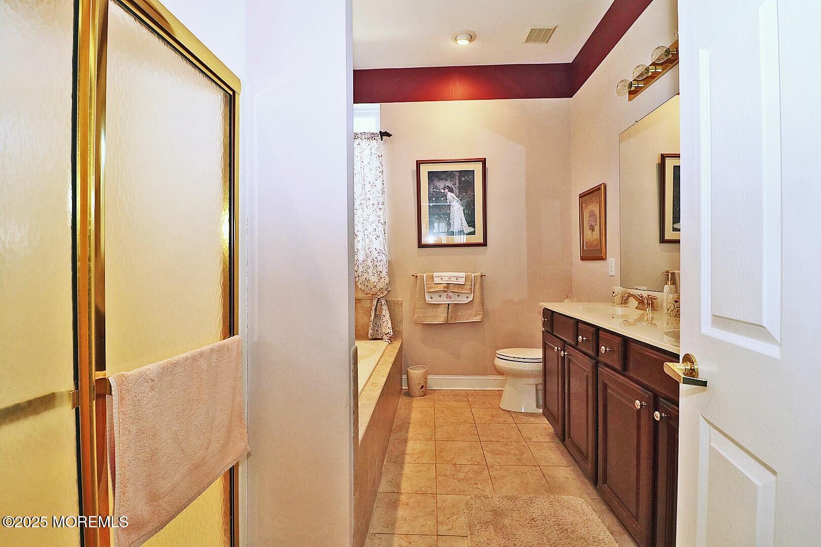 2 Manasquan Road Waretown, NJ 08758 - Photo 38 of 91 a bathroom with a sink a mirror and a bathtub