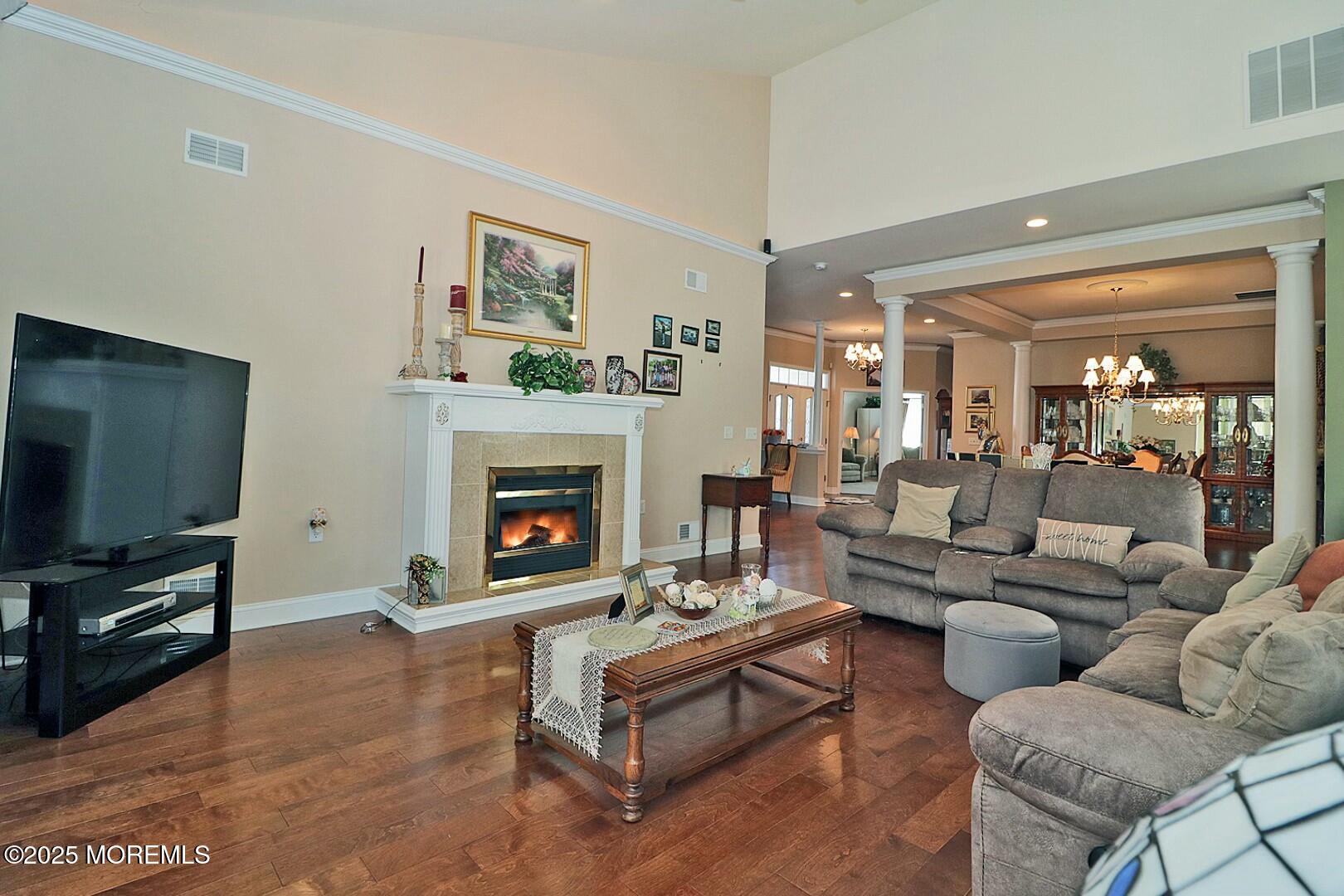 2 Manasquan Road Waretown, NJ 08758 - Photo 9 of 91 a living room with furniture a flat screen tv and a fireplace