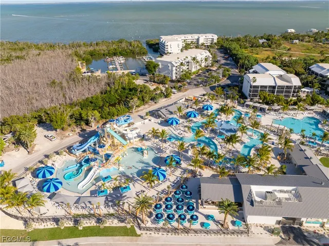 a view of a city with lawn chairs and large tree
