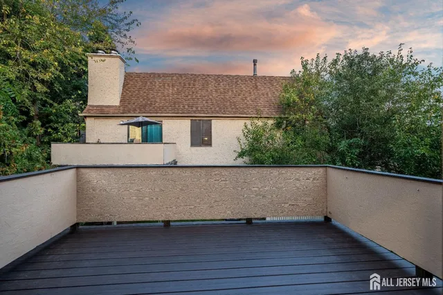 a view of balcony with wooden floor and fence