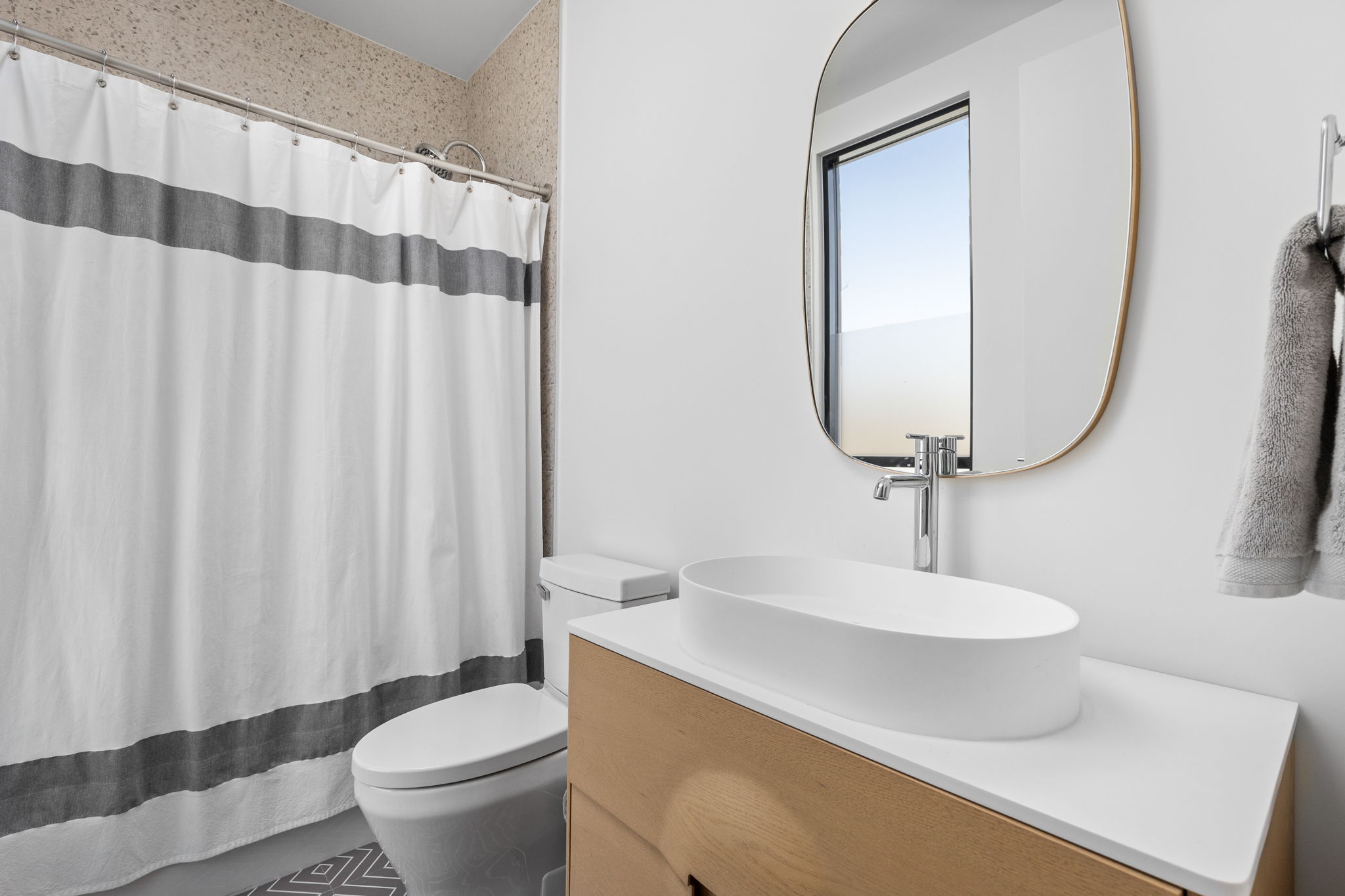 7502 St Louis Street Austin, TX 78757 - Photo 21 of 38 Full bath featuring vanity and a shower with shower curtain
