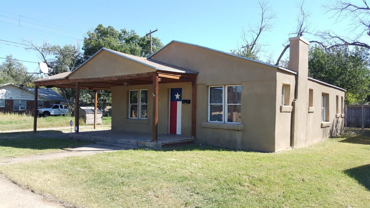 1807 18th Street Lubbock, TX 79401 - Photo 1 of 27 a front view of a house with a porch