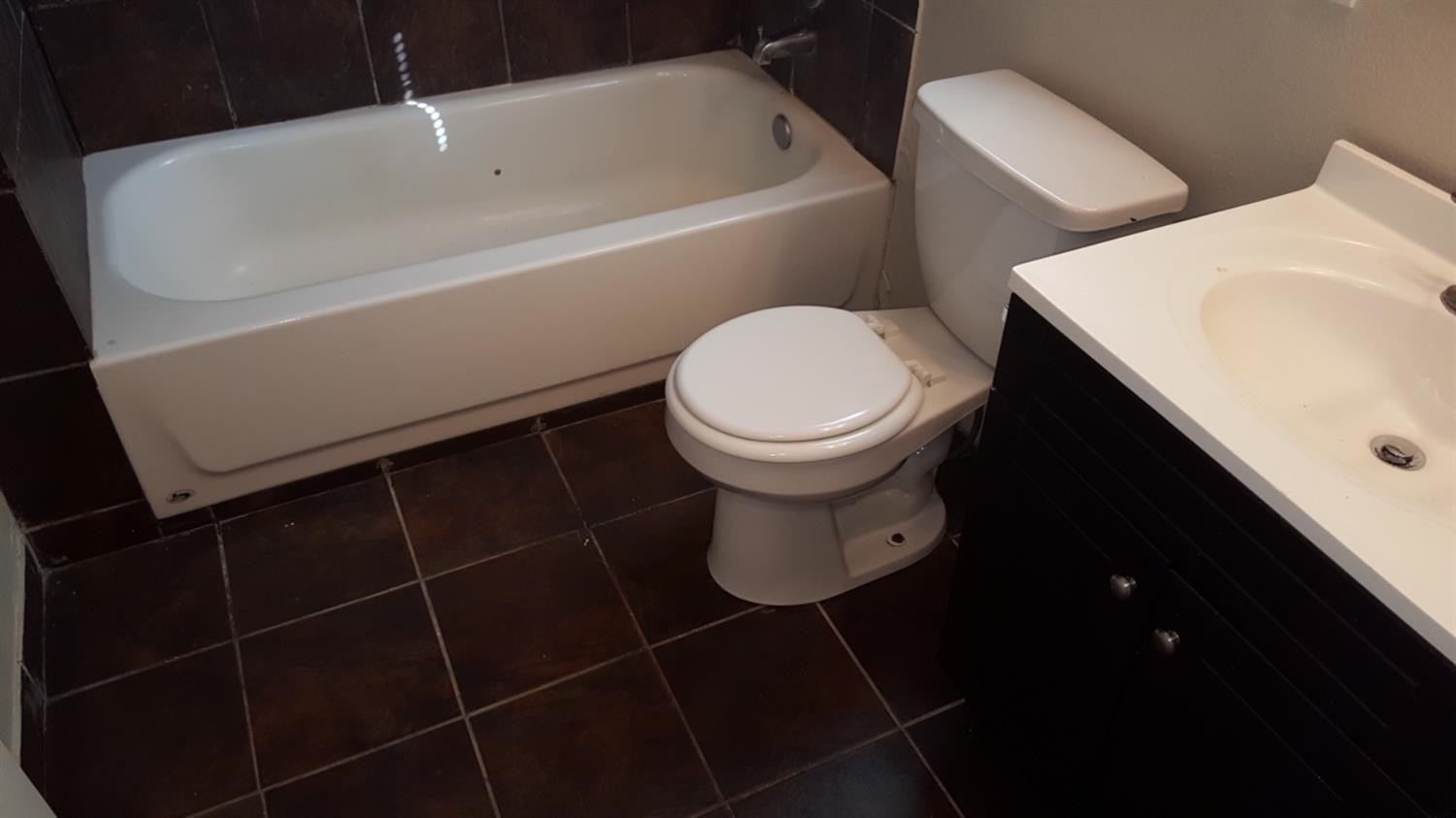 1807 18th Street Lubbock, TX 79401 - Photo 13 of 27 a bathroom with a toilet and a sink