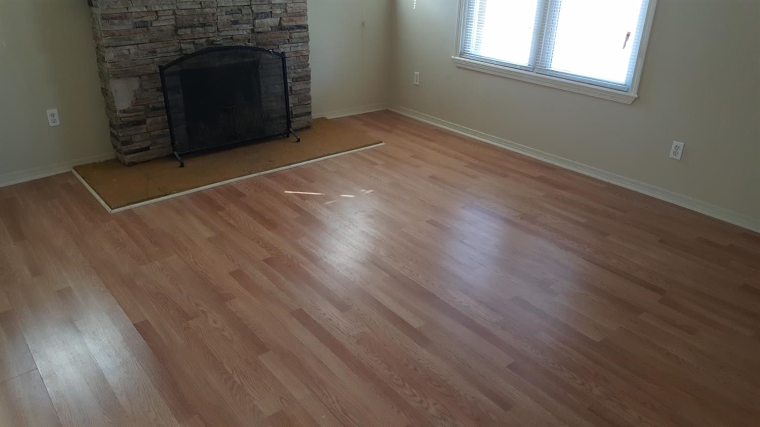 1807 18th Street Lubbock, TX 79401 - Photo 14 of 27 an empty room with wooden floor and fireplace